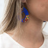Model wearing beaded teardrop earrings made by artisans in Kenya