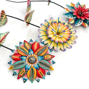 Colorful ceramic flower-shaped objects on a white background
