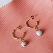 Gold hoop earrings with majok bead charms handmade in Haiti
