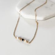 White, Gold, and Black Bead Necklace - FMSCMarketplace.org