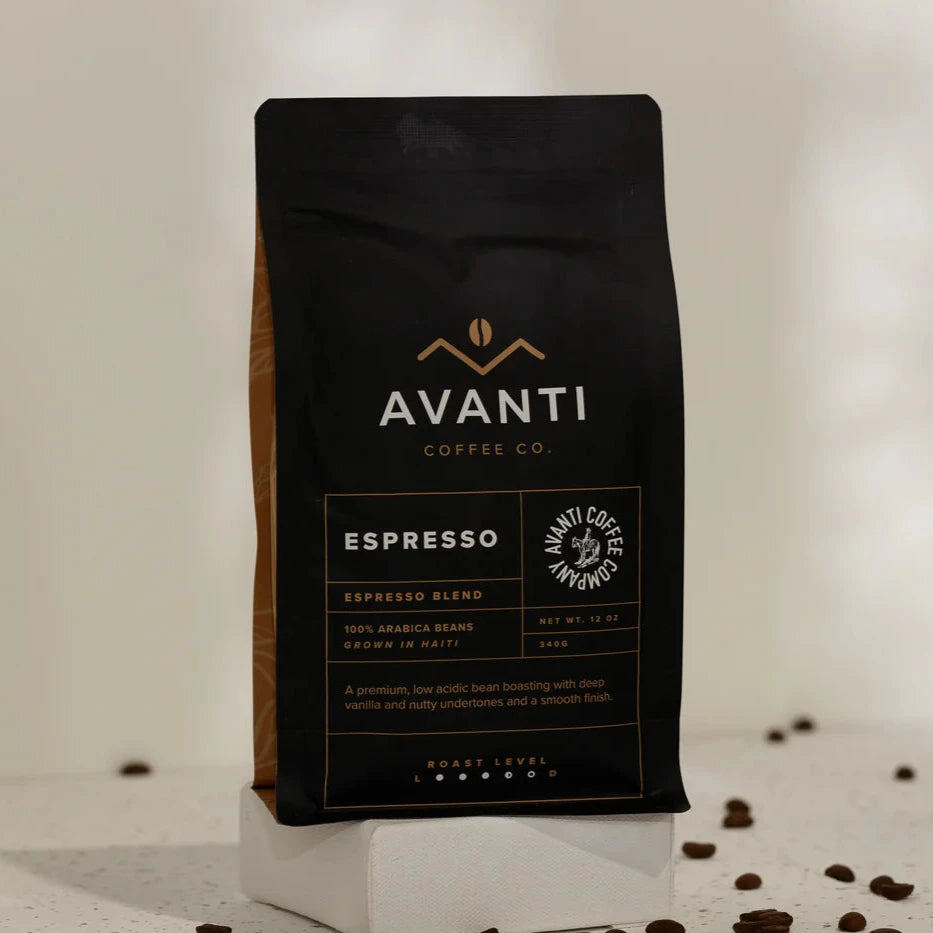 Avanti Coffee Co. Espresso coffee bag with scattered coffee beans on a light background