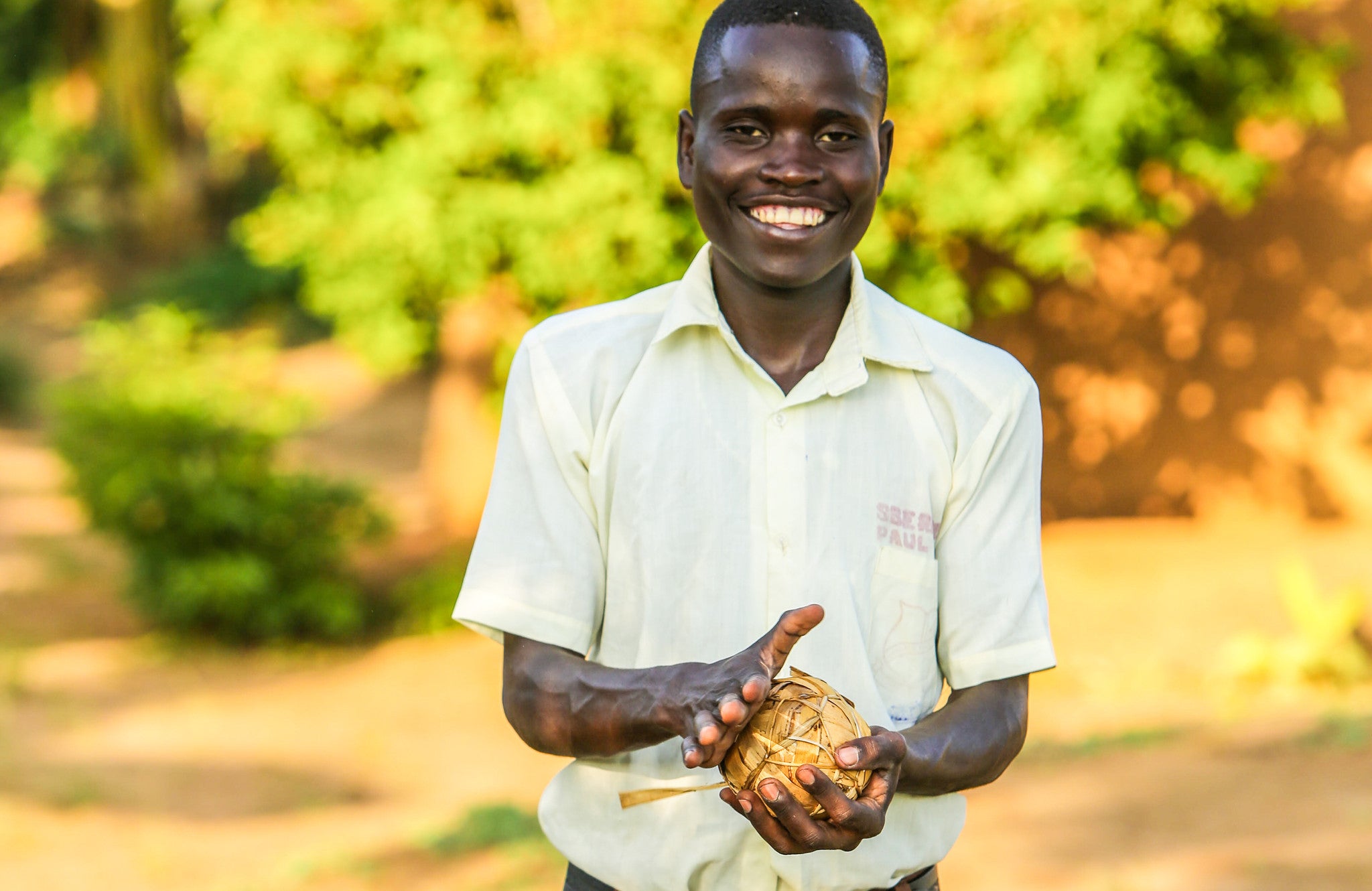 Boy with banana leaf soccer ball