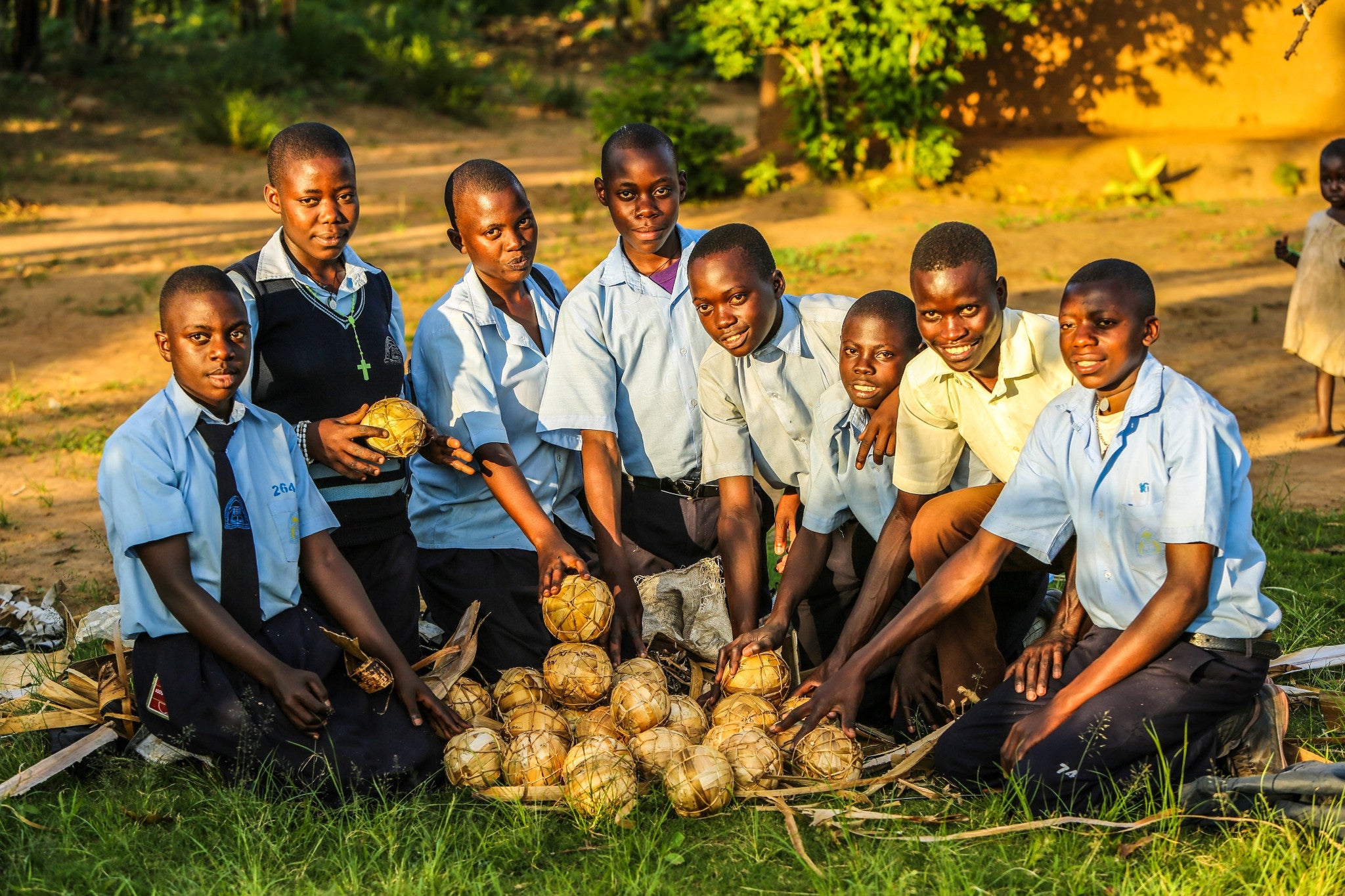 Group of boys with banana leaf soccer balls