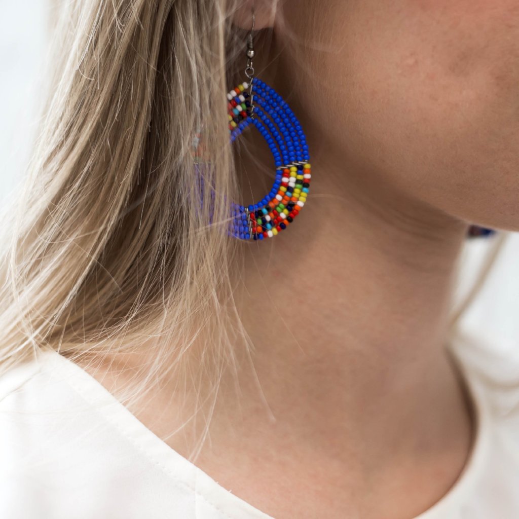 Model wearing beaded teardrop earrings made by artisans in Kenya